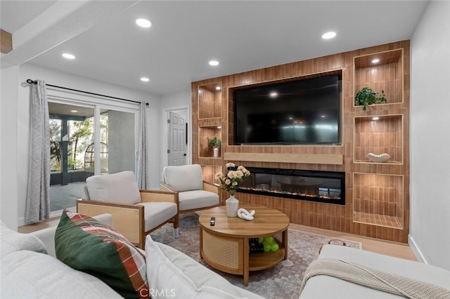 living area featuring recessed lighting and a fireplace