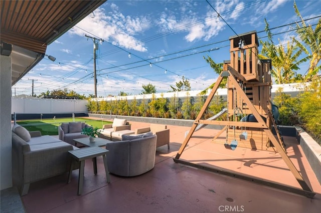 view of patio / terrace with a fenced backyard, an outdoor living space, and a playground