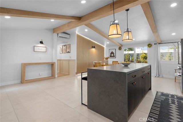 kitchen featuring decorative light fixtures, vaulted ceiling with beams, dark countertops, an AC wall unit, and dark cabinetry