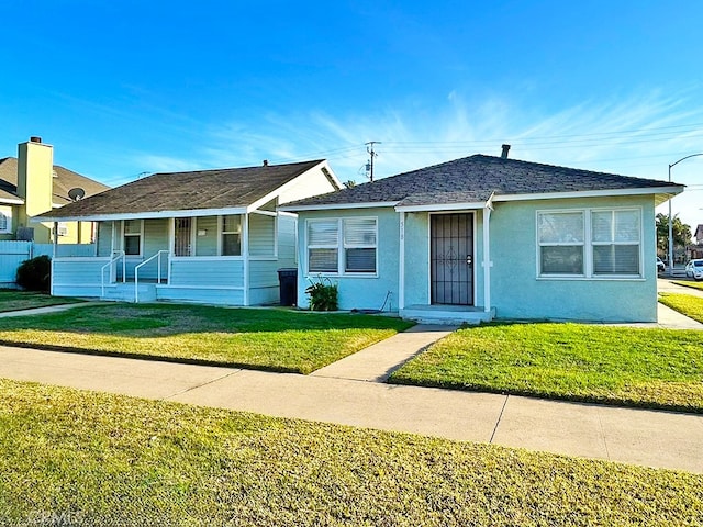 ranch-style house with covered porch and a front yard