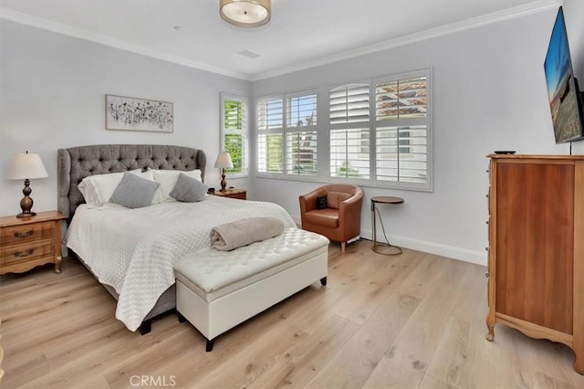 bedroom featuring crown molding, light wood-style flooring, and baseboards