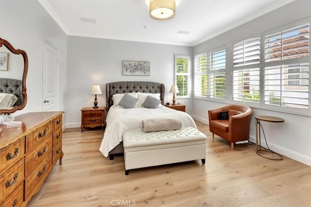 bedroom with light wood-style floors, baseboards, and ornamental molding