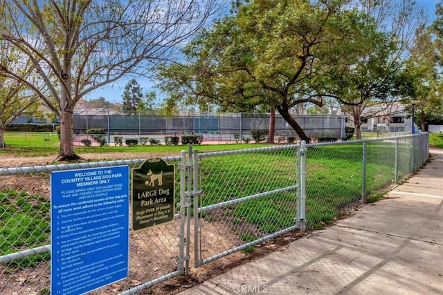 view of home's community featuring a yard and fence