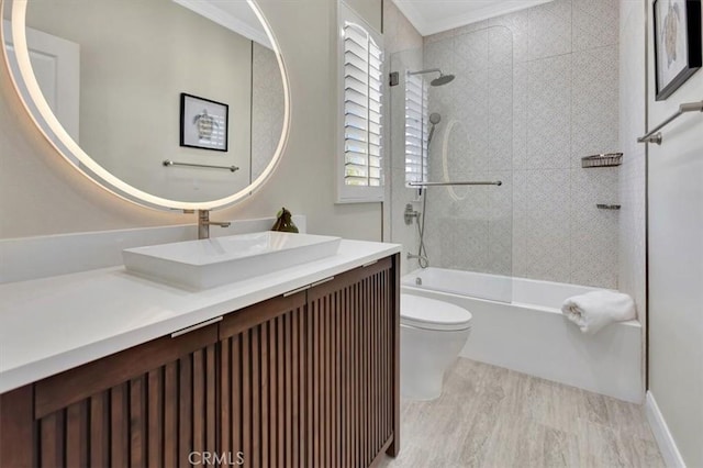 full bathroom featuring toilet,  shower combination, crown molding, and vanity