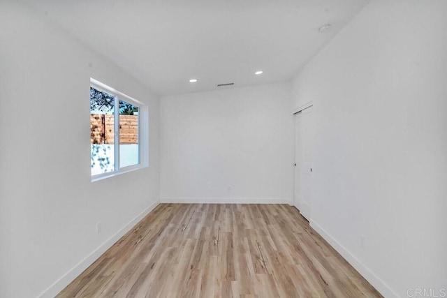 spare room with light hardwood / wood-style floors