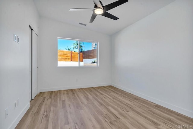 spare room featuring ceiling fan and light hardwood / wood-style flooring