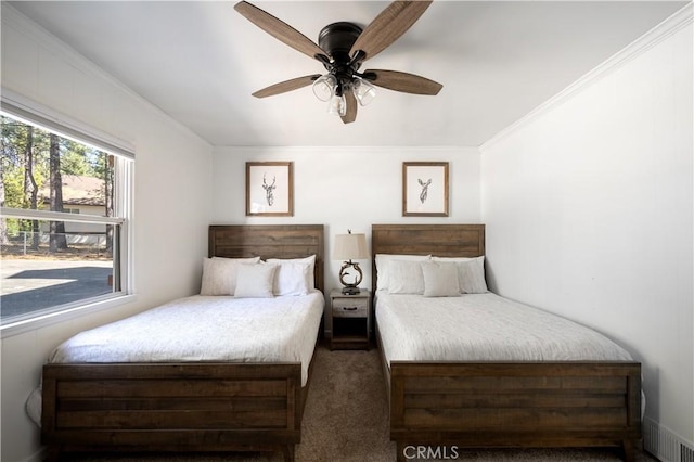 bedroom featuring ceiling fan, ornamental molding, and carpet