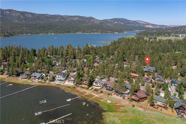 birds eye view of property with a water and mountain view