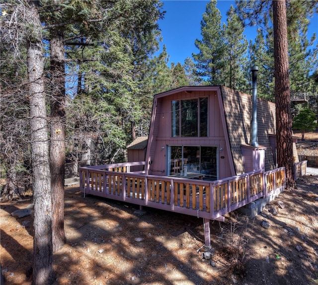 rear view of house with a wooden deck