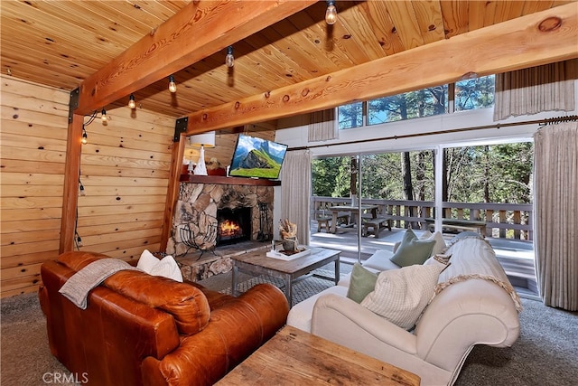 living room featuring carpet floors, wood walls, wooden ceiling, a fireplace, and beam ceiling