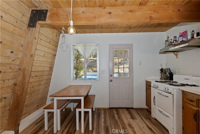 dining area with beamed ceiling, wood walls, wood-type flooring, and wood ceiling