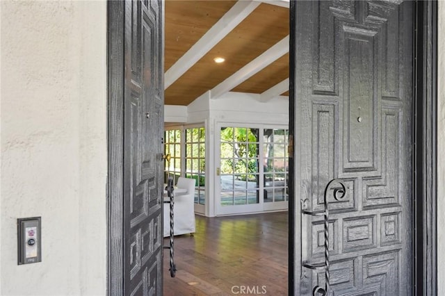 foyer with vaulted ceiling with beams, wood ceiling, and dark wood finished floors