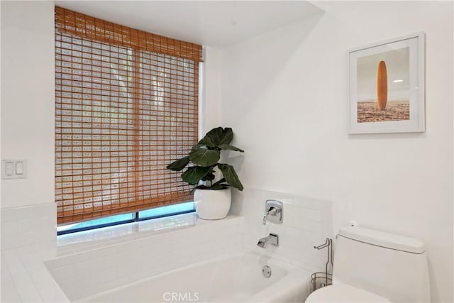 bathroom featuring a bath and toilet