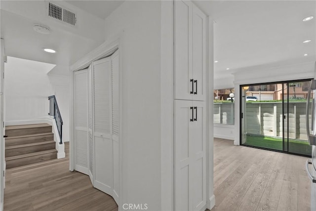 hallway with light hardwood / wood-style flooring