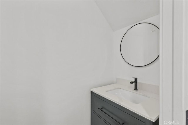 bathroom with vanity and vaulted ceiling