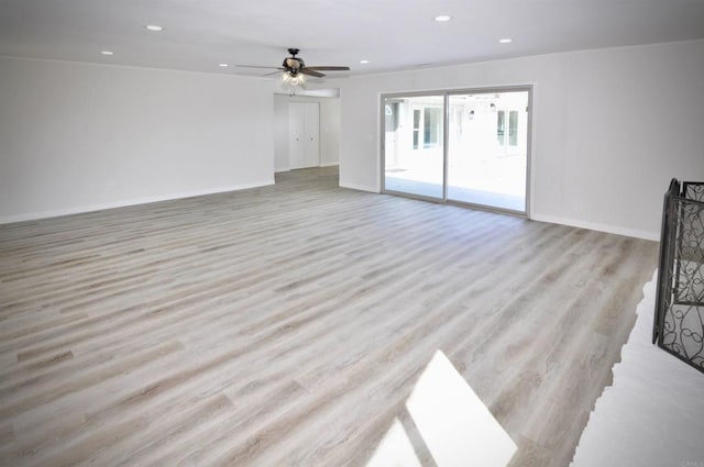 unfurnished living room featuring light wood-type flooring and ceiling fan