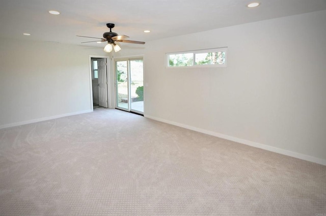 empty room with ceiling fan and light colored carpet