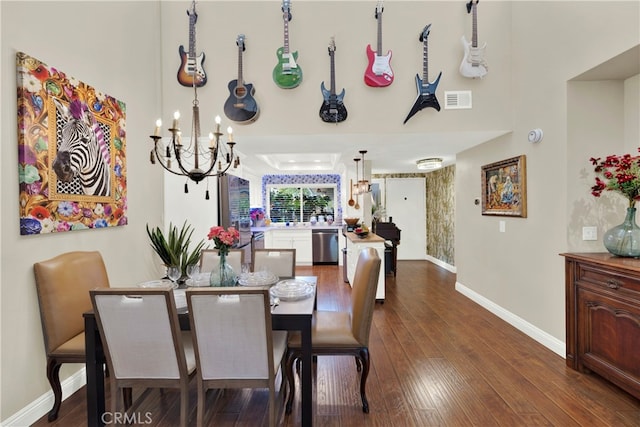 dining space featuring dark hardwood / wood-style floors and a notable chandelier