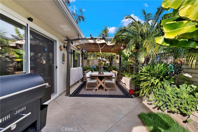 view of patio with area for grilling and a pergola