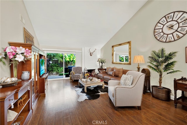 living room with a fireplace, high vaulted ceiling, and dark wood-type flooring