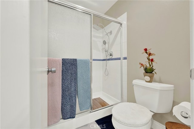 bathroom with toilet and walk in shower