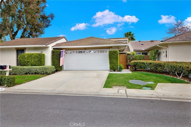 ranch-style house with a garage, concrete driveway, a tiled roof, and stucco siding