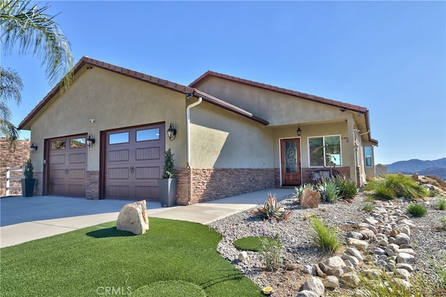 view of front of house featuring a mountain view and a garage