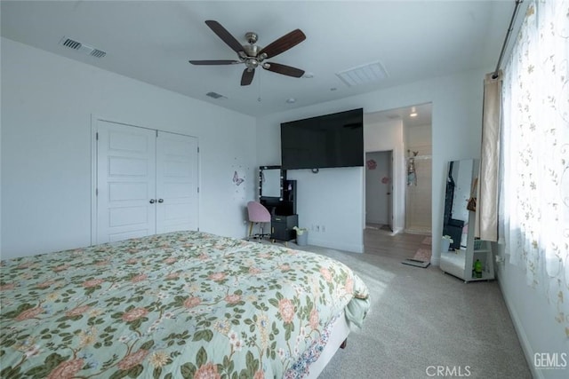 carpeted bedroom featuring multiple windows, a closet, and ceiling fan