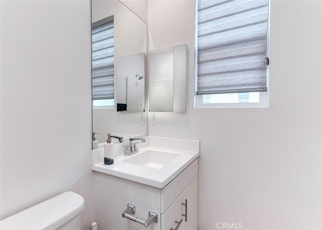 bathroom featuring toilet and vanity