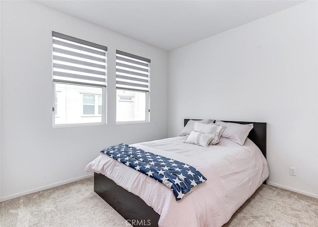 bedroom with light colored carpet