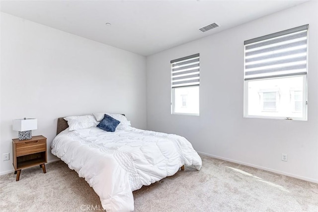 bedroom with light colored carpet