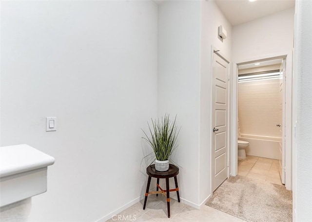 hallway featuring light tile patterned floors