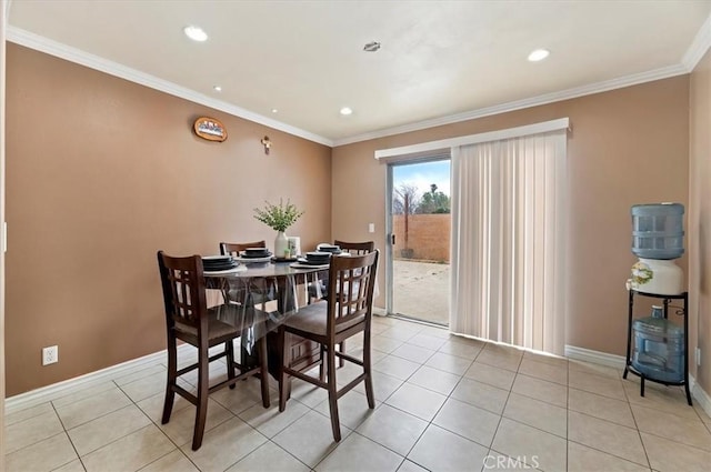 dining space featuring light tile patterned floors and crown molding