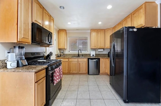 kitchen featuring dark stone countertops, sink, light tile patterned flooring, black appliances, and light brown cabinetry