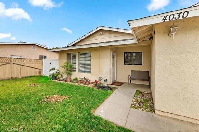 doorway to property featuring a yard