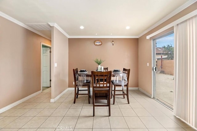 dining space featuring light tile patterned flooring and crown molding