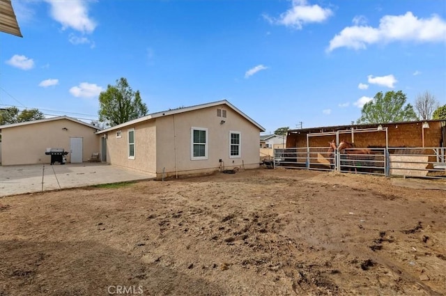 rear view of house with an outdoor structure