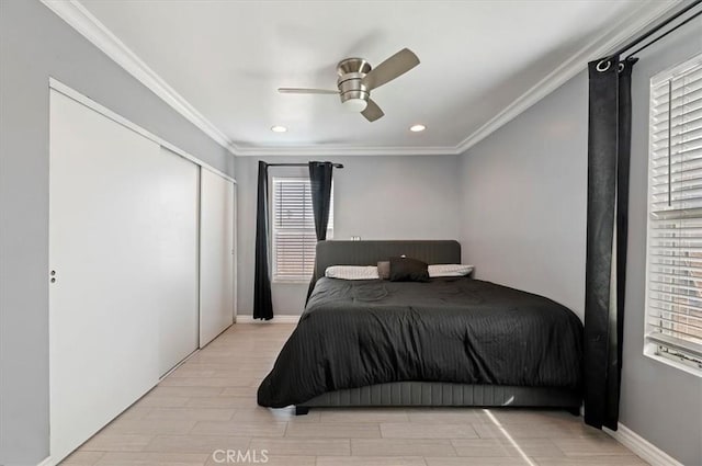 bedroom featuring ceiling fan, ornamental molding, light hardwood / wood-style floors, and a closet