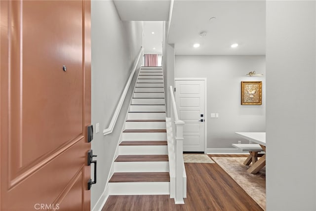 stairway with hardwood / wood-style flooring