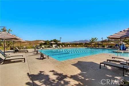 view of pool featuring a patio and a mountain view