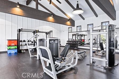 workout area featuring high vaulted ceiling