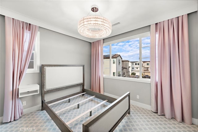 carpeted bedroom with an inviting chandelier