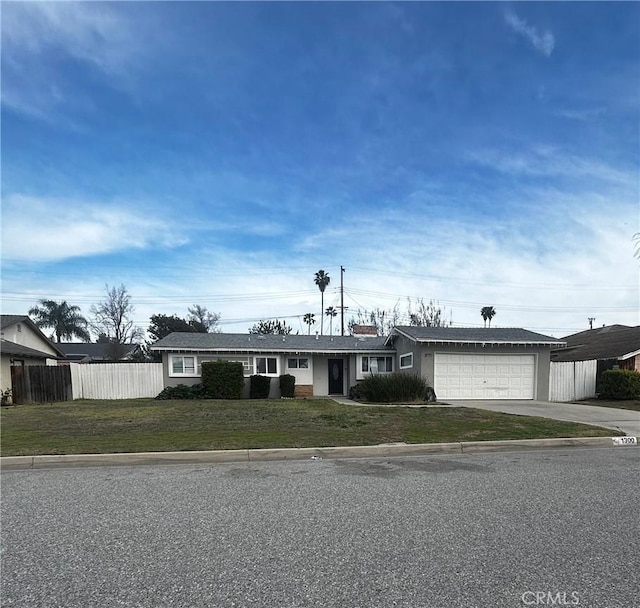 single story home with a front yard, an attached garage, driveway, and fence