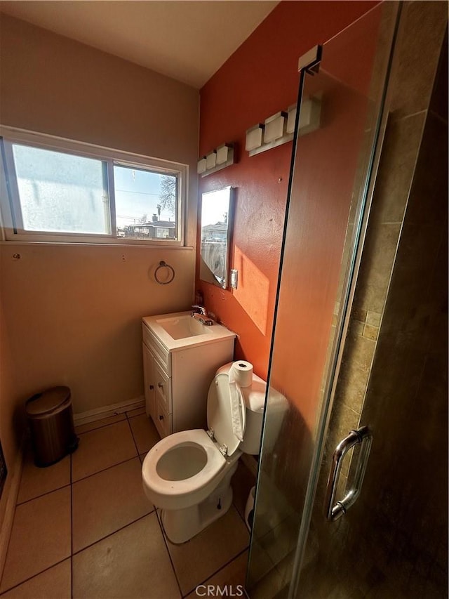 full bath with toilet, a shower stall, tile patterned flooring, baseboards, and vanity