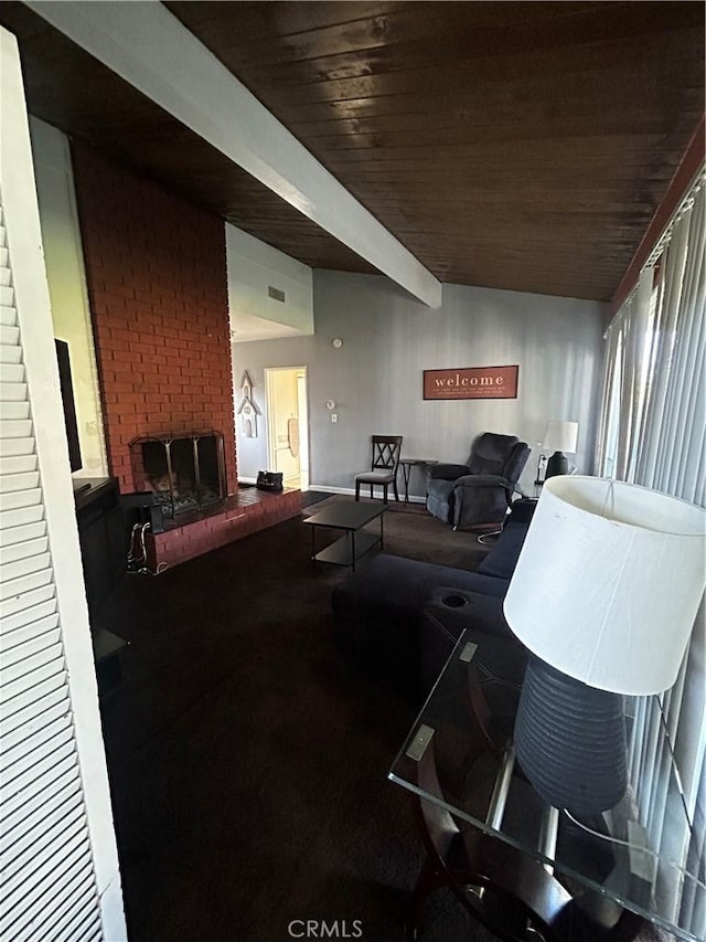 living room with beam ceiling, a brick fireplace, and wooden ceiling