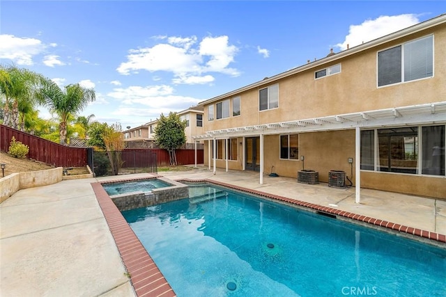 view of swimming pool featuring a fenced backyard, a pool with connected hot tub, and a patio