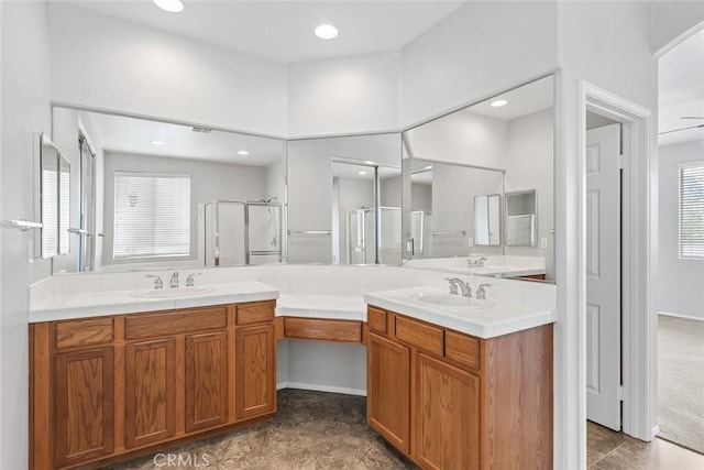 bathroom featuring a shower stall, vanity, and a healthy amount of sunlight