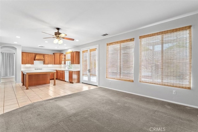kitchen with white dishwasher, light countertops, ceiling fan, recessed lighting, and custom range hood