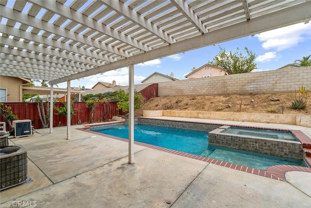 view of pool with central AC unit, a fenced backyard, a pool with connected hot tub, and a patio area