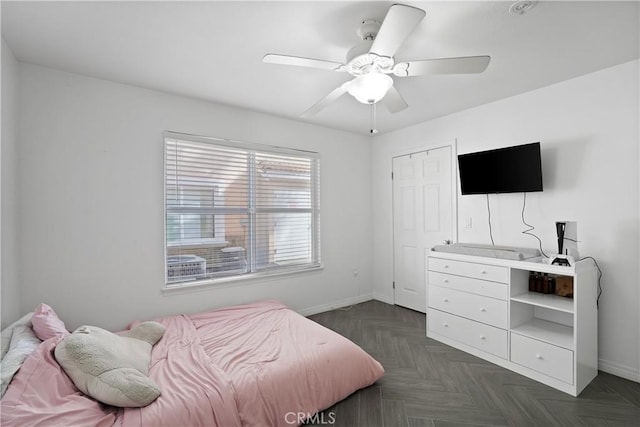 bedroom with dark parquet flooring and ceiling fan